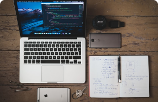 A desk with many electronic devices.